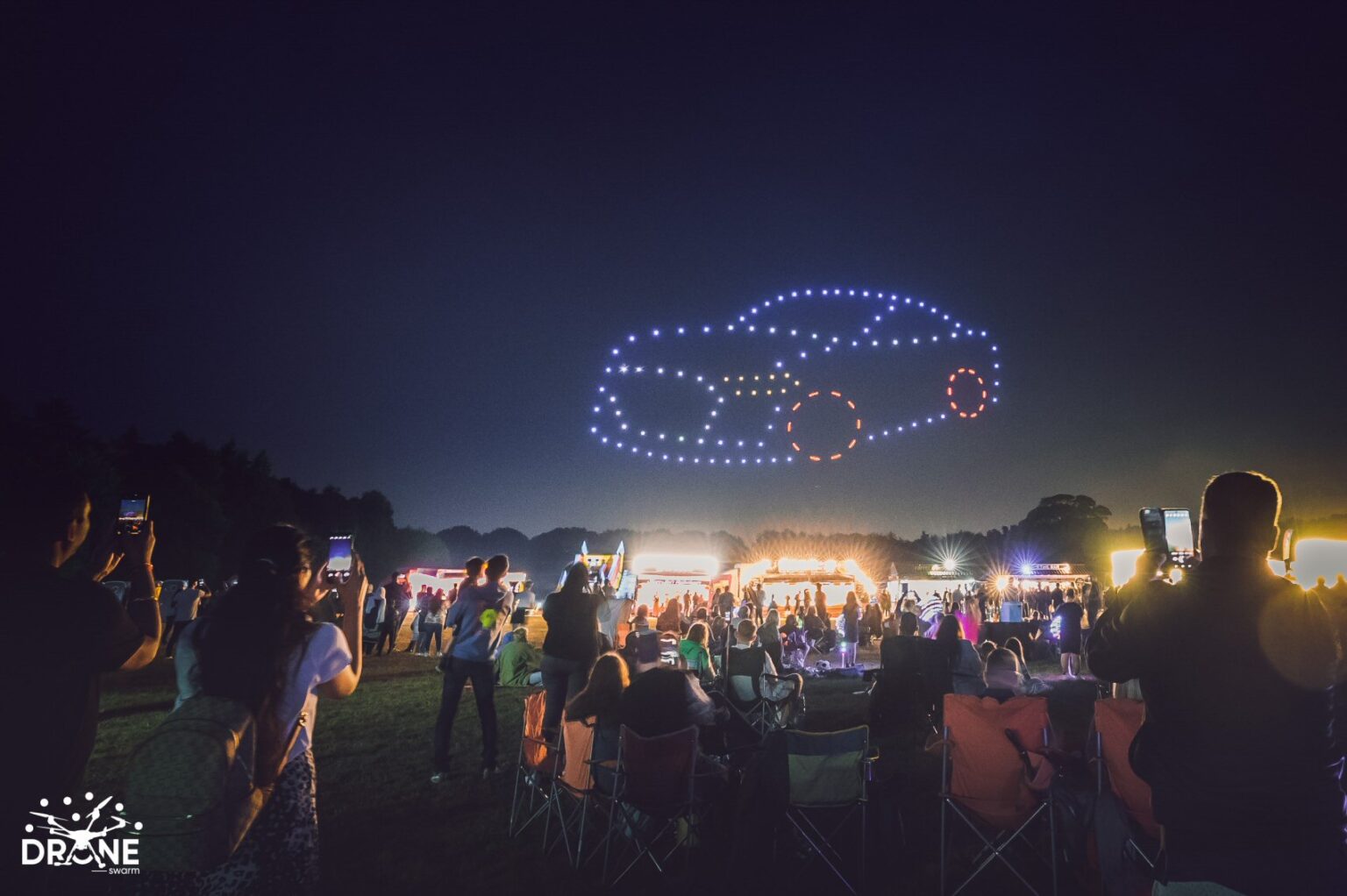 Spectators watching a DroneSwarm display at Hatfield Park