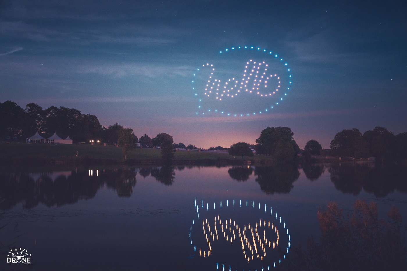 A colourful drone formation reflected in the lake at Ragley Hall
